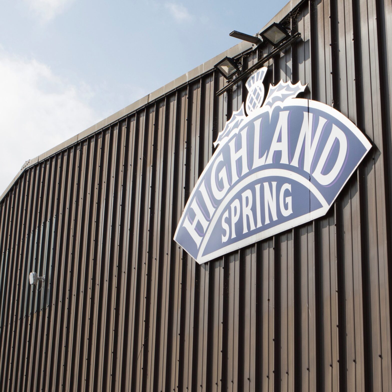 Tamlite Highland Spring Water building exterior image with logo