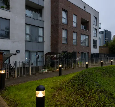 Residential building at dusk with bollard lighting